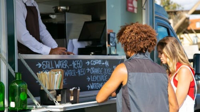 Two customers ordering at a food truck - building customer loyalty in a small business setting