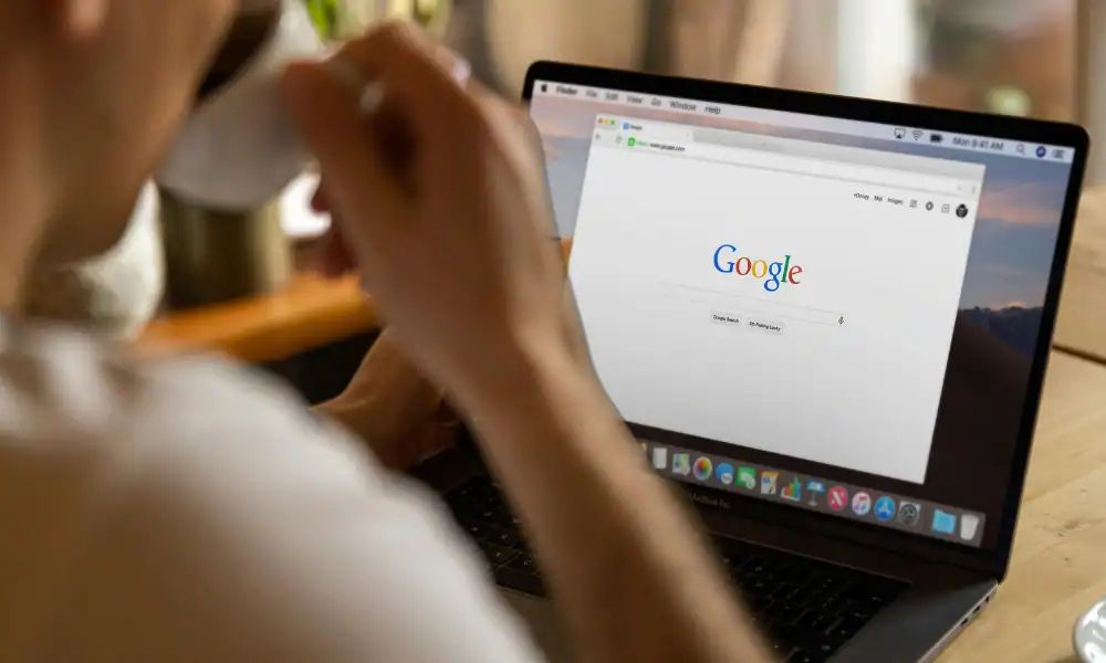 A person using his laptop and searching for google reviews for real estate agents