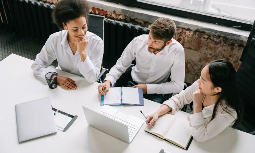 A small business team planning their blog marketing for small business content strategy together in a meeting.