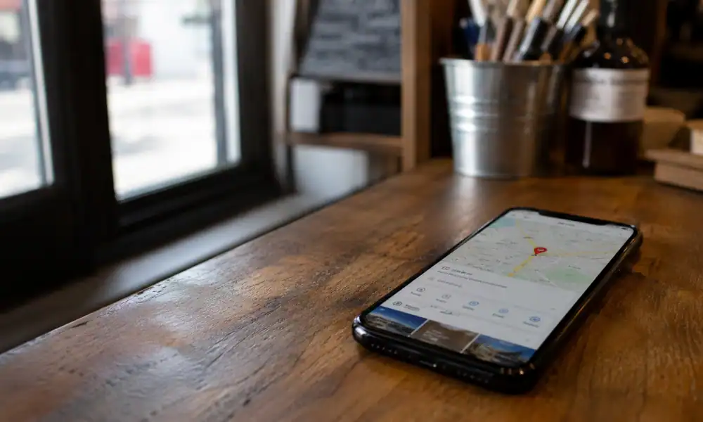 Smartphone on a shop counter showing a Google Maps listing, illustrating a Google Business Profile not getting calls.